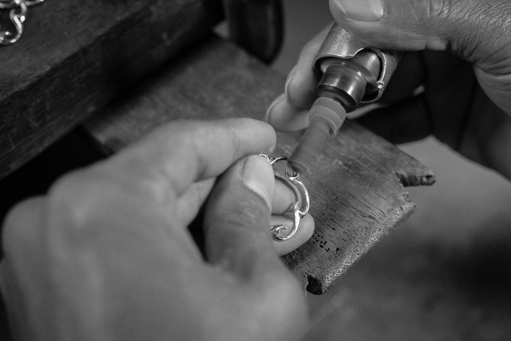 Photo of Jeweller's hands using a polishing tool