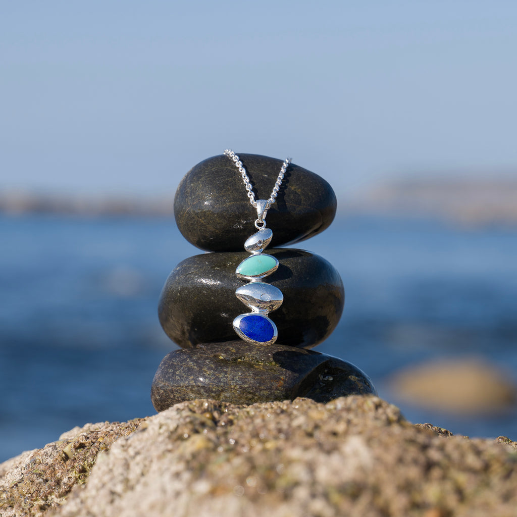 Necklace placed on a stack of pebbles